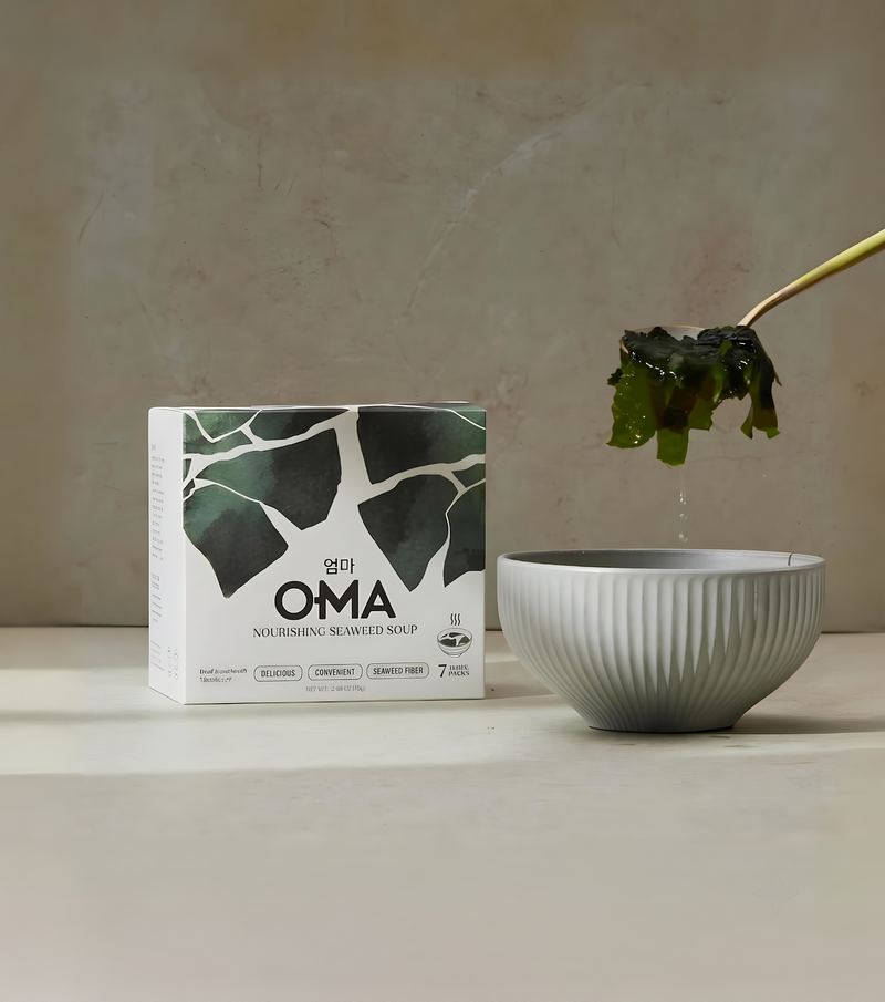 OMA seaweed soup box beside a ceramic bowl with seaweed lifted by chopsticks